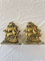 Pair of brass sailing ship bookends front view