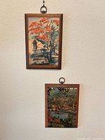 Both framed prints hanging on wall