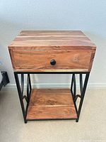 Front view showing drawer, knob, shelf, and metal frame