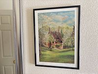 Front view of framed cottage print on wall