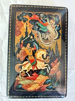 Top view showing painted folklore scene and gold border