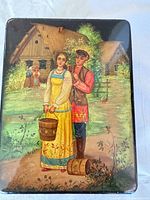 Top view showing painted Palekh folk scene on lid