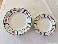 Stack of eight large plates beside stack of four smaller bowls showing pattern and quantity