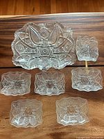 Entire set laid out: large bowl, six small dishes, metal rod handle