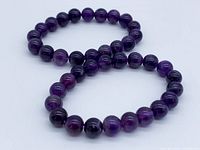 Two amethyst stretch bracelets arranged side by side