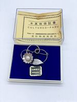 Brooch in original box with guarantee card