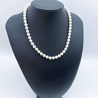 Full view of pearl necklace on display bust