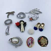 Front view of all eleven brooches