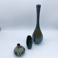 Group shot of all three vases: tall glass, ceramic bud, stone torpedo