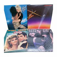 Group shot of four vinyl record jackets front covers
