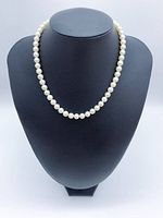Full view of pearl necklace on display bust