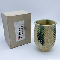 Teacup with box front view shows glaze and pattern