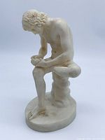 Front left view of A. Santini Spinario sculpture showing full figure and base