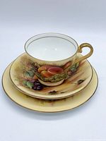 Cup stacked on saucer and plate displaying full trio and artwork