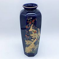 Full frontal view of cobalt blue octagonal vase with gold peacock design