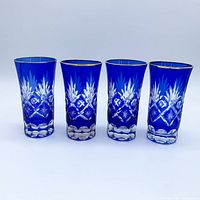 Front view of four cobalt cut crystal glasses
