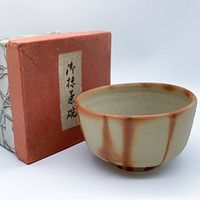 Matcha bowl beside its wood box showing exterior design