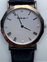Front view showing dial, case shape, markers, diamonds