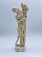 Full view of cream figurine on round base