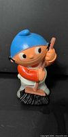 front view of boy figurine holding broom