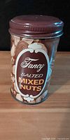 Front view of Fancy Salted Mixed Nuts tin with lid