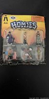 Front view of sealed Homies Series 6 blister pack with six figurines