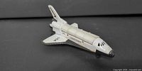 Left front quarter view of NASA space shuttle miniature showing decals and fuselage