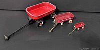 Three miniature Radio Flyer wagons grouped by size