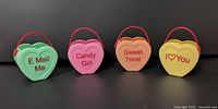 Front view of all four heart buckets showing colors and slogans