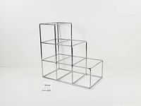 front angled view showing stepped chrome wire cube structure