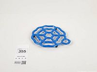 Top view of blue openwork cast iron trivet