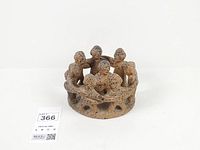 Front view of terracotta sculpture showing linked figures and overall form