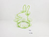 Front view of green wire bunny egg holder showing spiral baskets and overall form