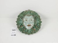 Full frontal view of ceramic Green Lady plaque