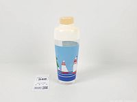 Full view of shaker front showing sailboats graphic and plastic lid