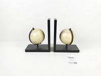 Front view of both globe bookends showing overall design and layout