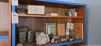 Full bookcase shelf with rock specimens, technical books and Taylor gauge