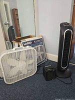 All three appliances: Lasko box fan, Honeywell tower fan, Heat Express space heater with box behind fan
