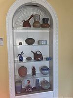 Full view of built-in display showing all ceramic and glass items