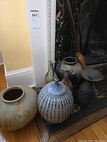 Group of six ceramic vessels on hearth