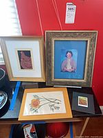 Group view of all four framed prints on table