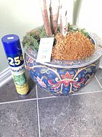 FloraLife Leaf Shine can beside ceramic floral pot showing size and pot design