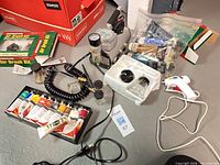 Overview of compressor, paint tubes, glue gun, airbrush kits