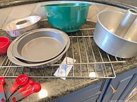 Overview of all bakeware and utensils on cooling rack