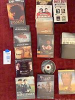 Overview of all DVD cases and loose disc laid out on red surface