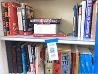 Overall view of two shelves of books showing titles and condition