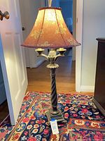 Full view of metal lamp with shade showing candle holders and overall design