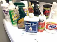 Group of assorted cleaning supplies on appliance top