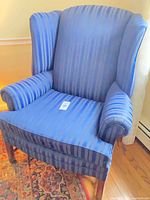 Front view of blue striped wingback chair