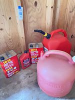 Full lot showing both gasoline cans, two TruFuel cans and motor-oil bottle